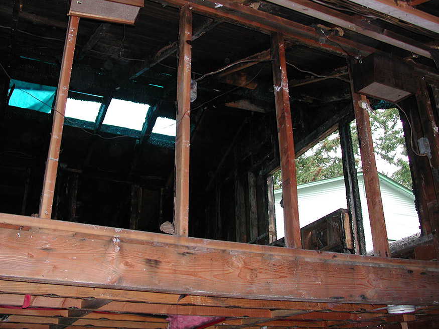 View of the damaged living room area before the remodel