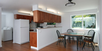 View of the open plan dining and kitchen from the living room