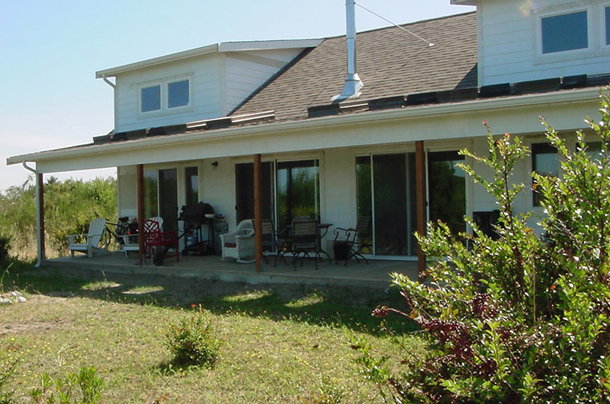 The rear of the house has large windows to enjoy the view and shading to prevent overheating.